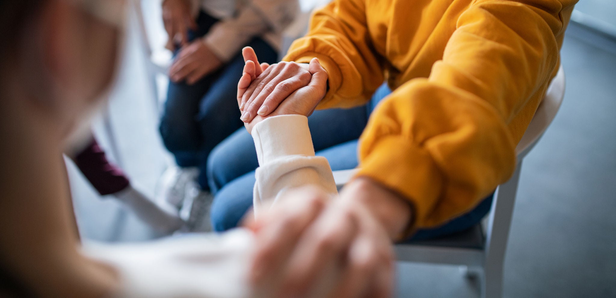 People supporting one another on grief therapy session.