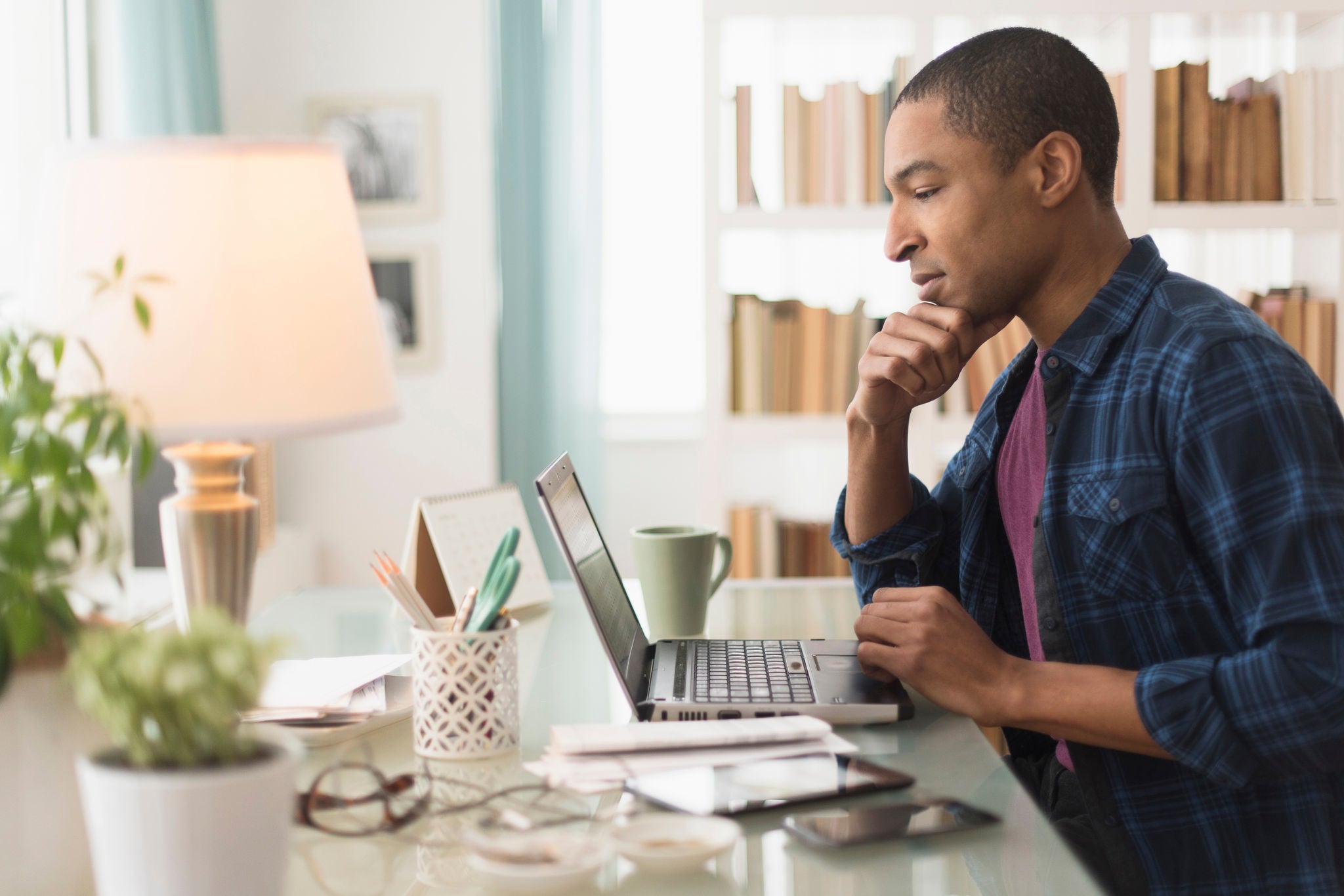 Black businessman working on laptop at desk