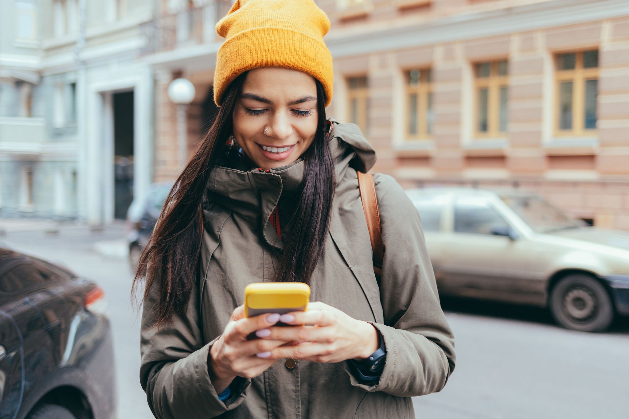 Attractive young woman tourist talking on mobile phone in the city