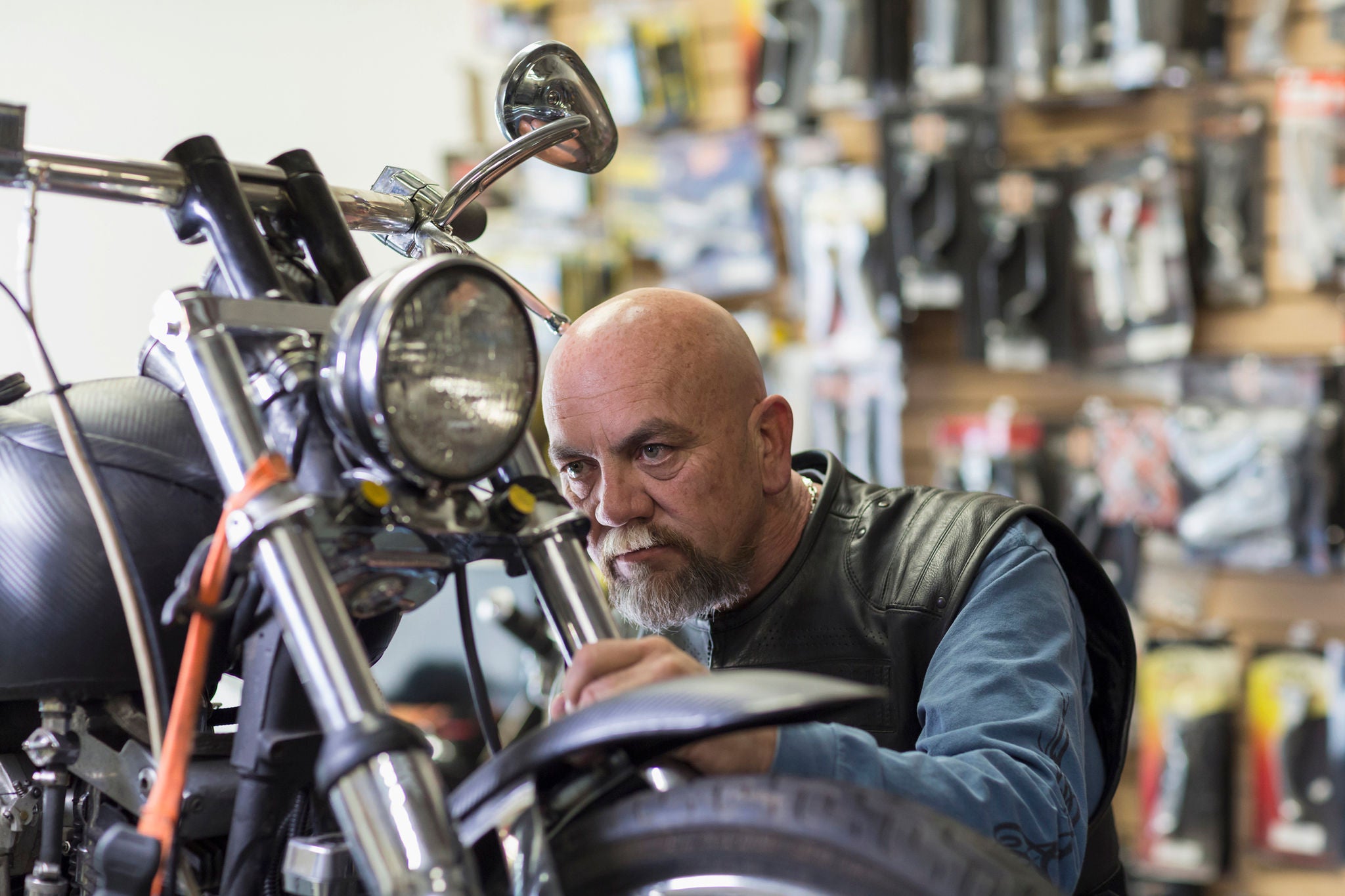 Caucasian man repairing motorcycle