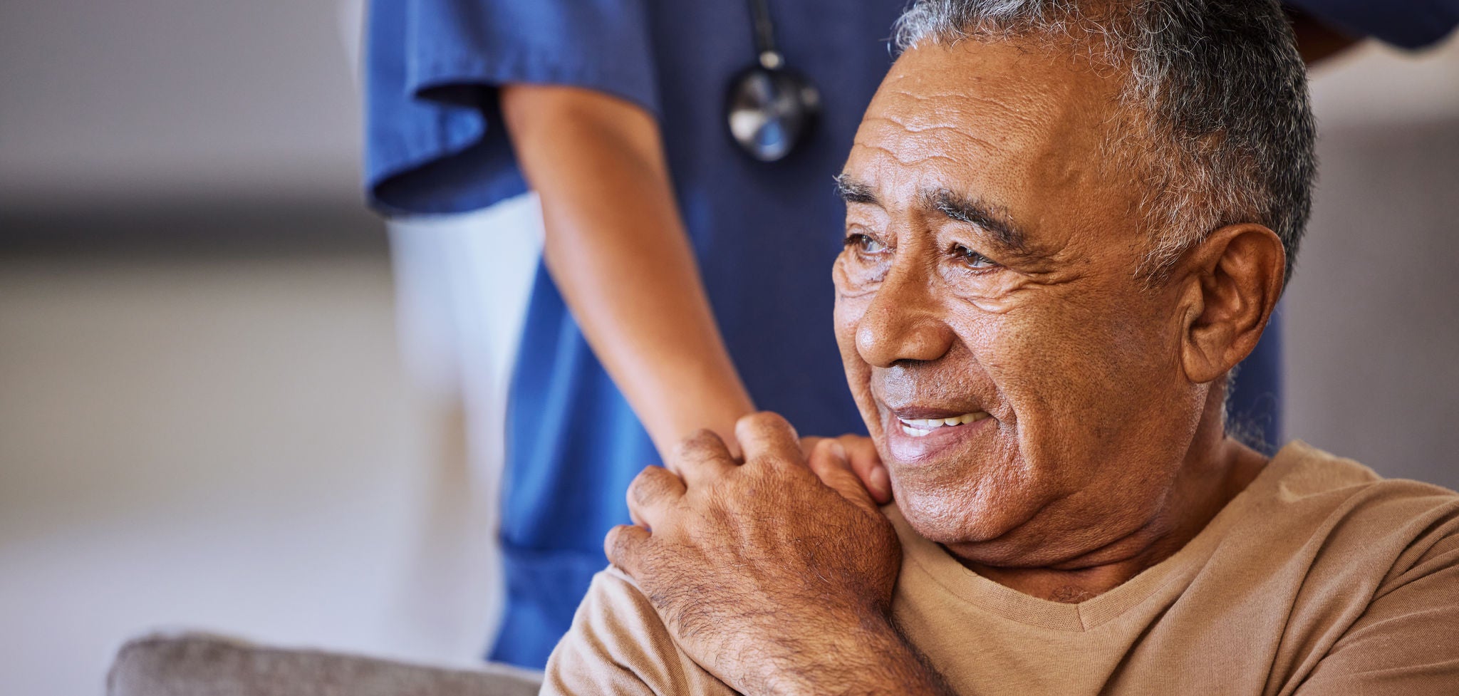 Nurse or doctor offer their man support during recovery or loss. Caregiver holding hand of her sad senior patient and showing kindness while doing a checkup at a retirement, old age home or hospital