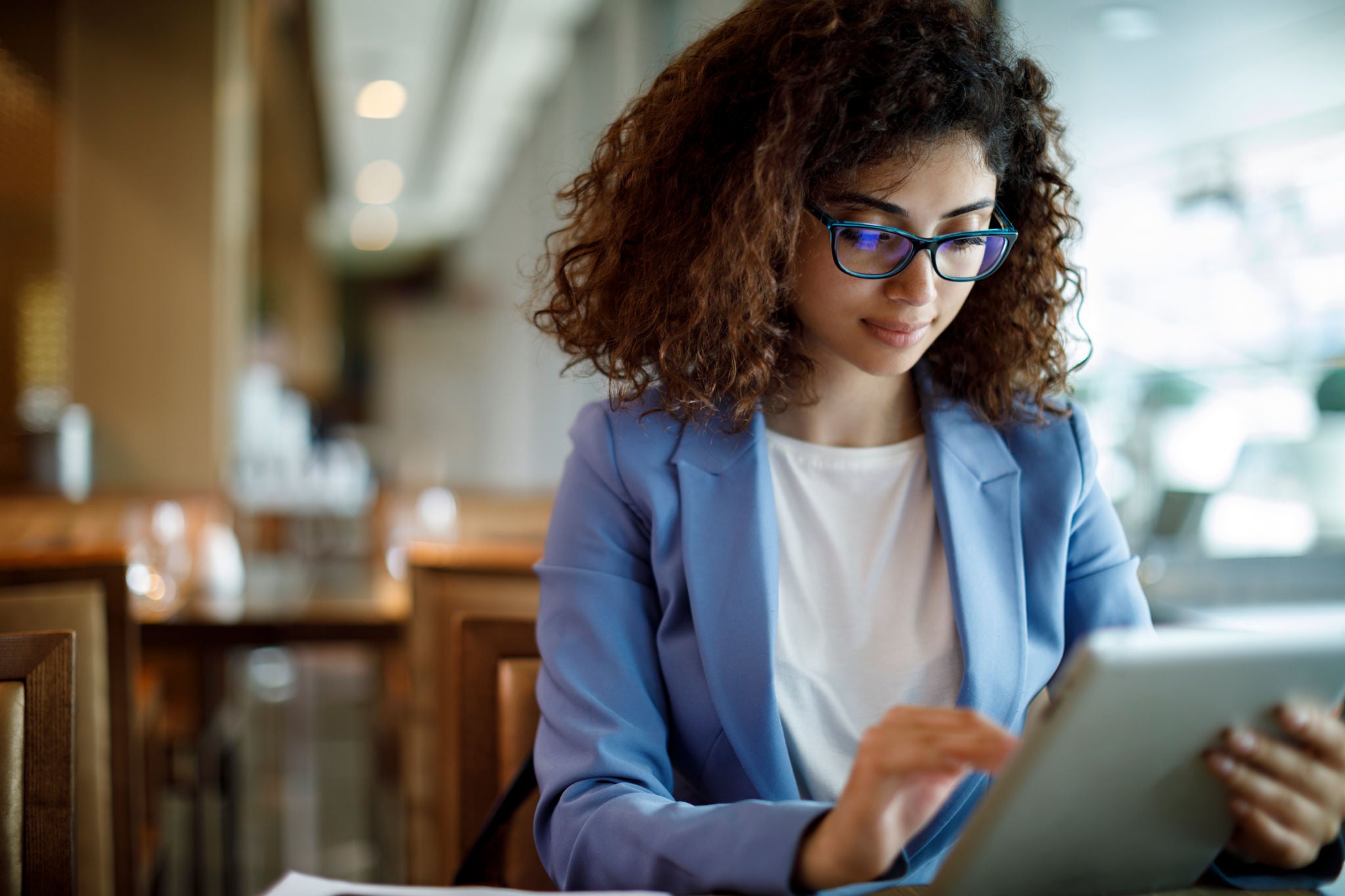 Businesswoman using digital tablet at a cafe