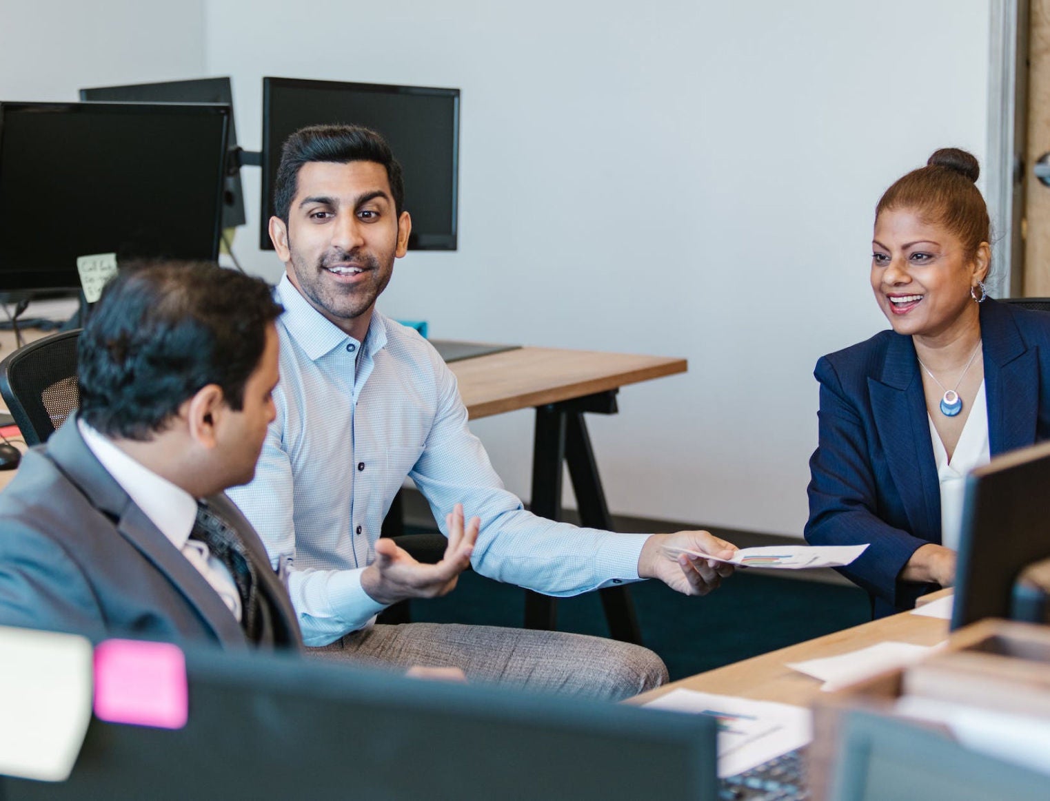 Three professionals in a meeting