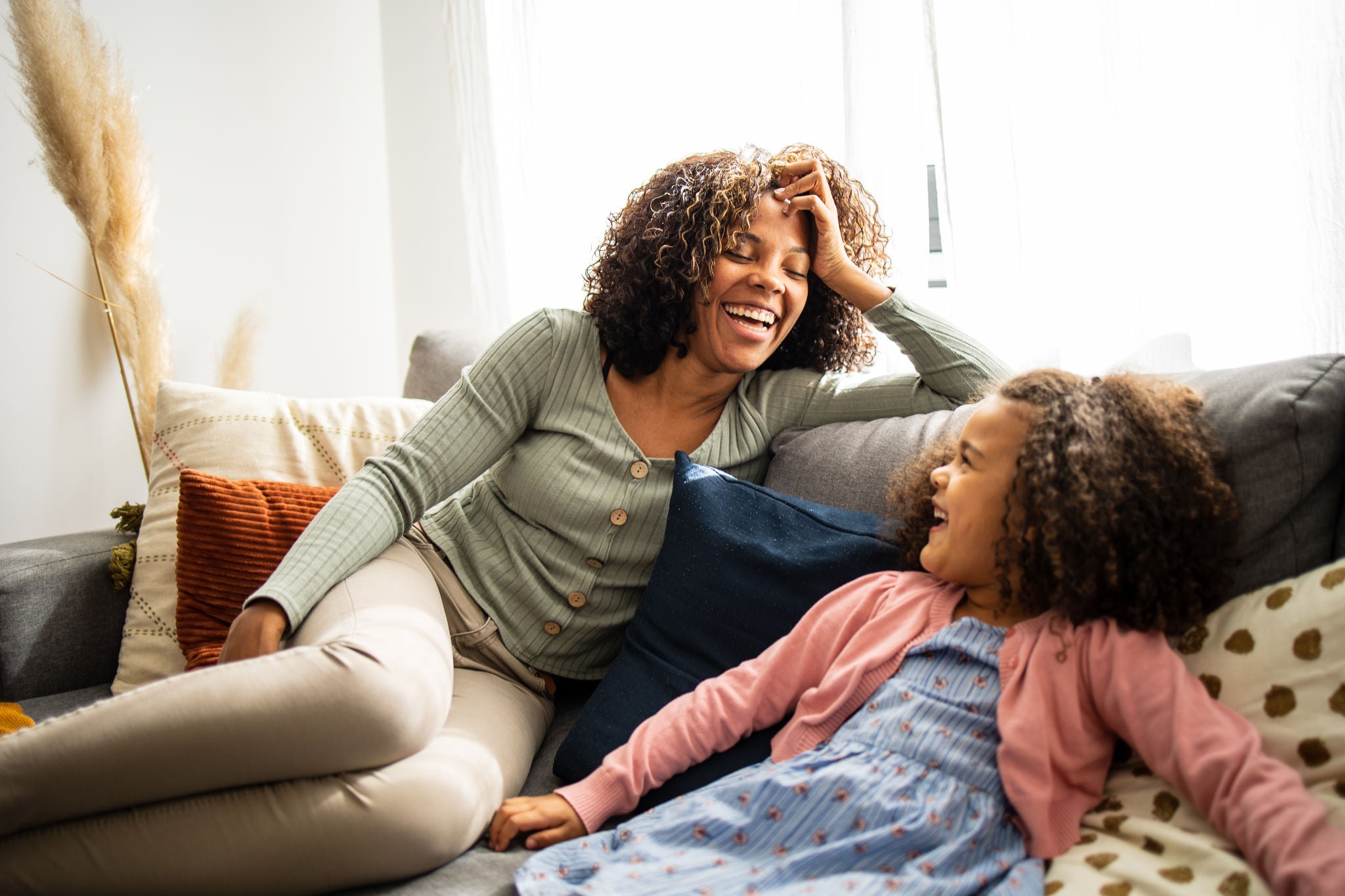 Mother and daughter having fun in the living room