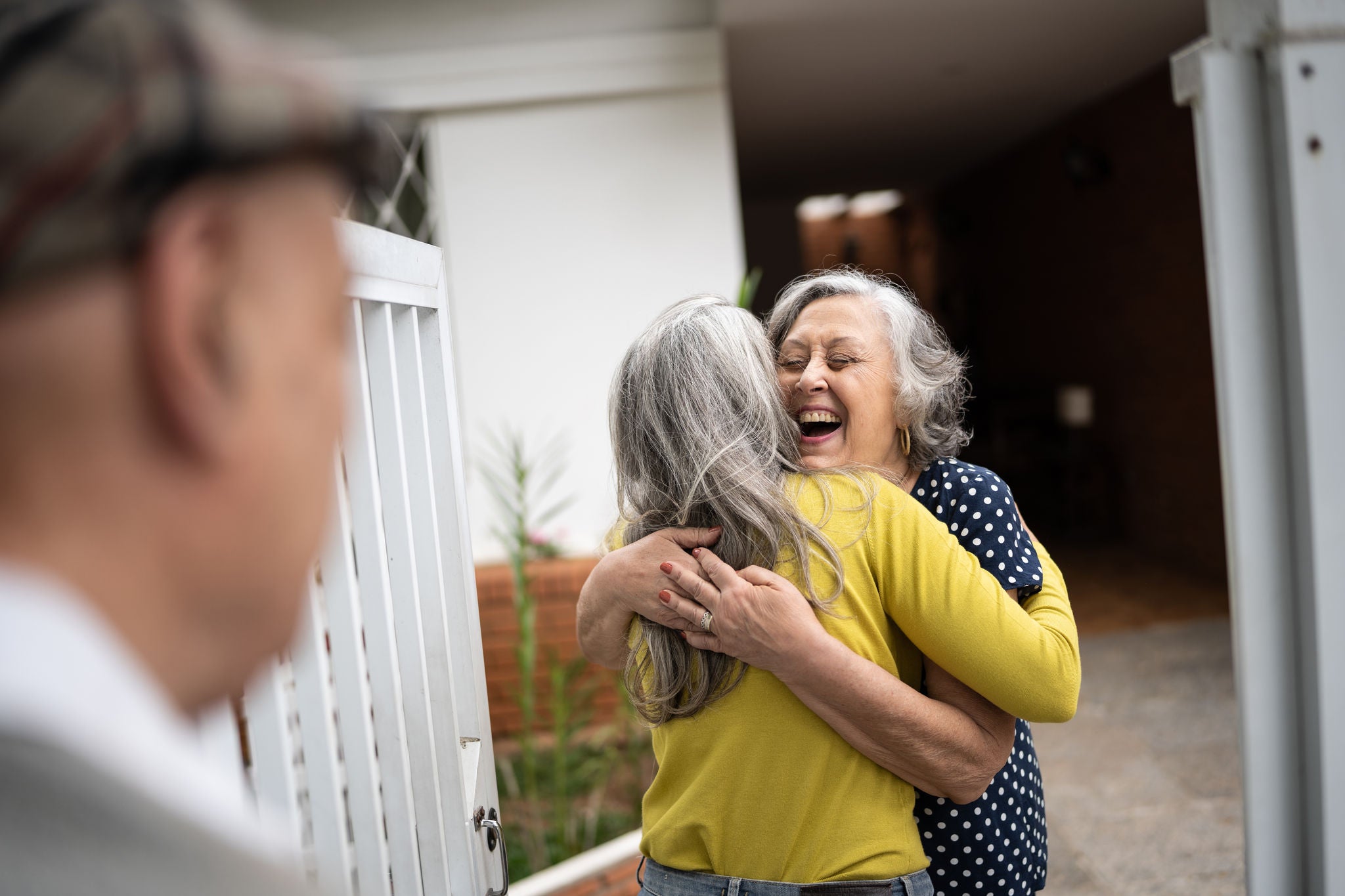 Mother welcoming husband and daughter at home